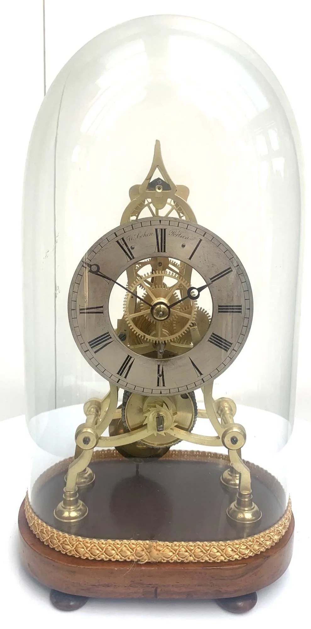 ساعت رومیزی اسکلتی آنتیک برنجی با حباب شیشهای و پایه چوبی